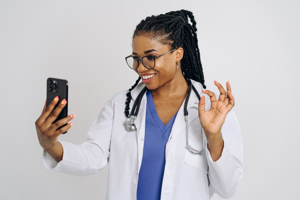 Same doctor giving an OK sign after earning a referral reward